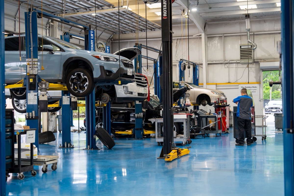Adams Automotive shop floor with technicians working in the bays